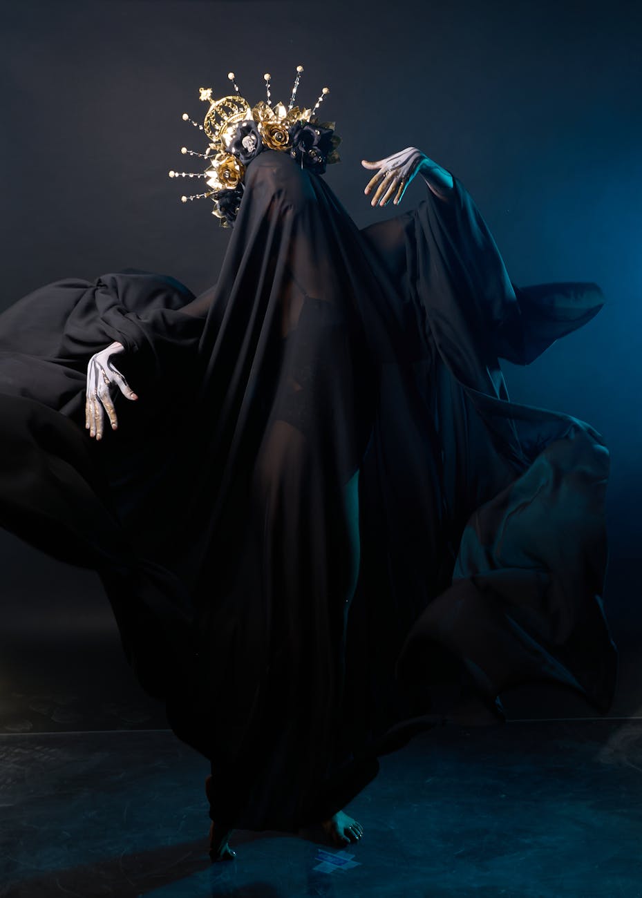dark veiled figure with ornate headpiece