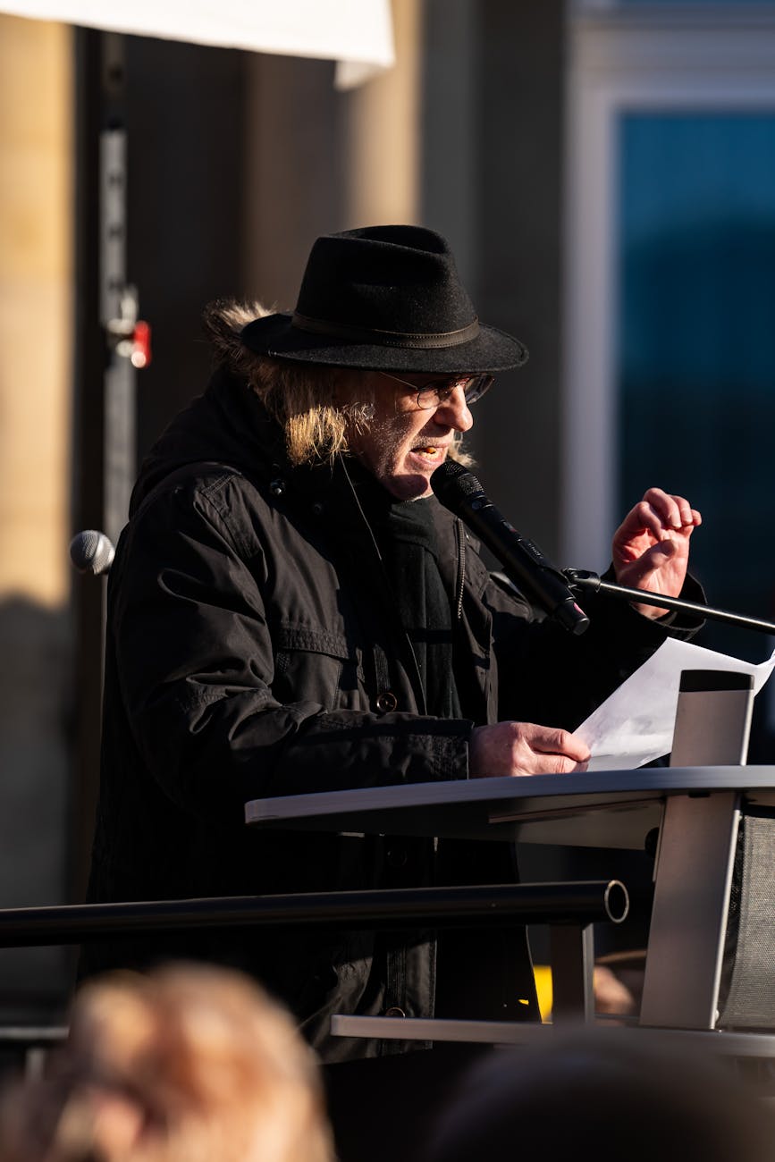 man speaking on a street demonstration